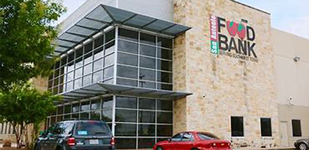Photo of two-story brick building with glass windows and a light brick exterior.
